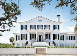 Recipient of two regional Aurora awards for custom home building, this house encompasses 6,129 total square feet. A crushed stone drive lined with live oak trees leads to the front entry. Handmade brick steps up to a refined garden space and beyond to the columned portico.