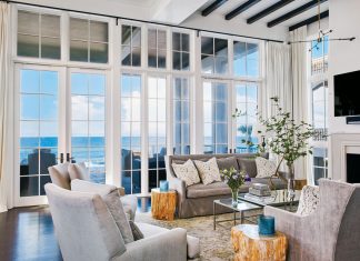 Soaring 12-foot-tall windows and doors in the living room display a panoramic ocean view just beyond the loggia and pool. Plush furnishings include Lee Industries’ sofas and chairs, petrified-wood accent tables from Bernhardt and Oly’s mirror-topped cocktail table.