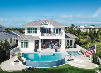 Encased in sparkling glass mosaic tiles, the half-moon pool and its sister spa by Nassau Pools are joined below by a nearly beachside firepit. Enamored with her home, owner Michele Harrison says, “I think we’ll stay!”