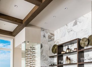 A wave of Presario’s unpolished Lumen White stone from Hadinger wraps the walls in cool comfort. Pulling up to SunMac’s leather-finished quartzite countertop, Brownstone’s sand-blasted teak “Beach” barstools bring the warmth.
