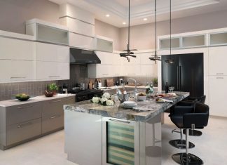 “This kitchen countertop is the drama queen that has to be the center of attention,” Davenport says. Two-toned iridescent cabinets, painted glass subway tile backsplashes, and grounding black elements such as bar stools and other fixtures come together to create a glamorous place to sip wine and snack as the main course is being prepared.