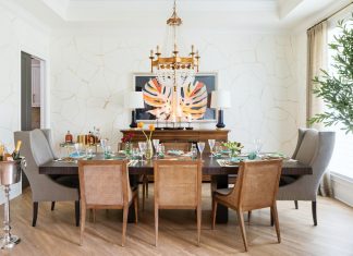 Lisa Gilmore hired local artist Meaghan Scalise to create a marbled wallpaper and hung a vibrant banana leaf print for a pop of color. Mixing traditional pieces—like the client’s mother’s cocktail cart and a vintage chandelier—with modern pieces results in a chic-yet-approachable space that’s perfect for family gatherings.