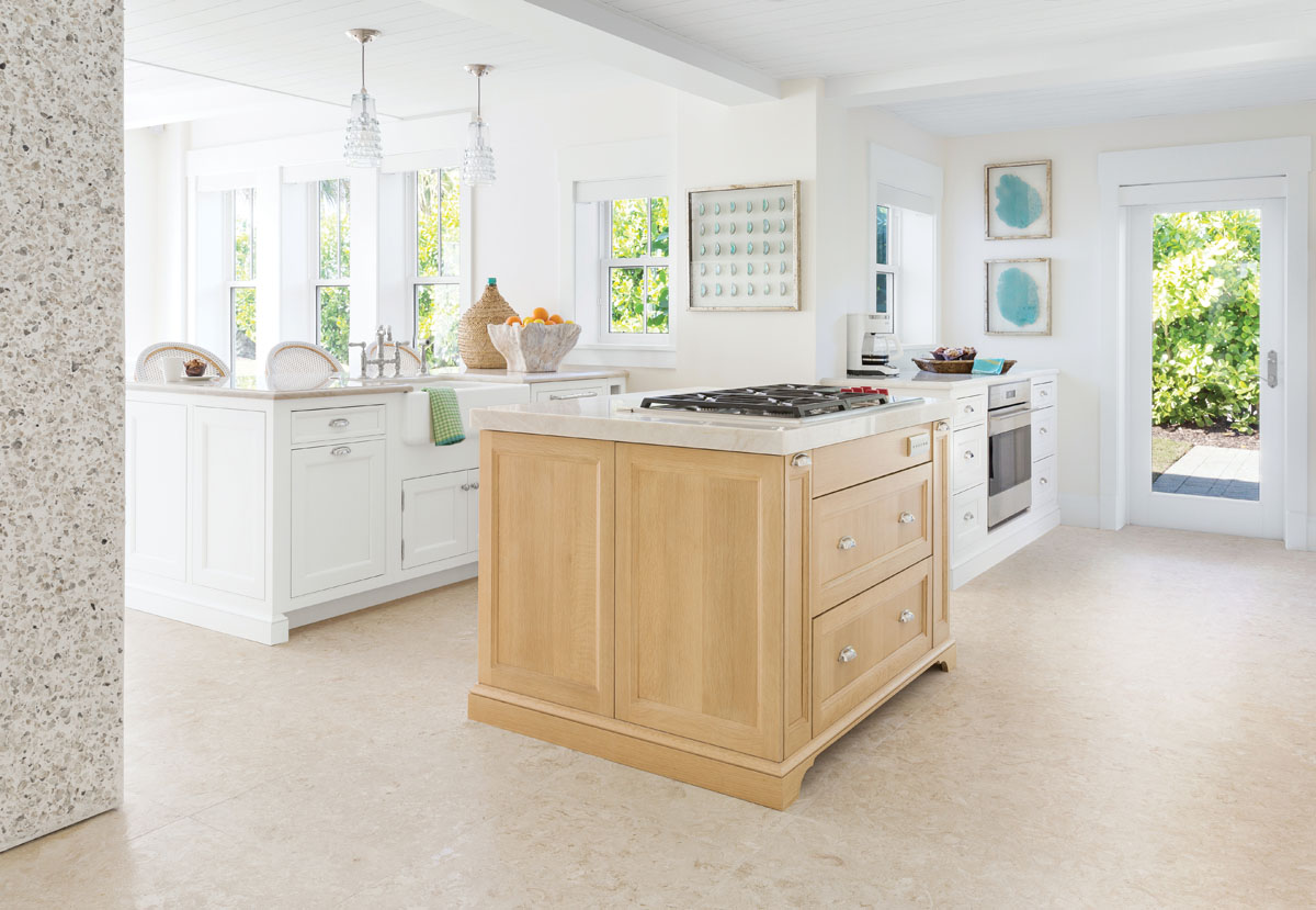 Just off the dining area, the kitchen&rsquo;s oak island is a gathering spot for family. French barstools in woven plastic are simple to keep clean and light enough to move around with ease. Just behind the barstools is a small seating area with four club chairs and an ottoman. &ldquo;We did maximum seating in the house and nothing fussy,&rdquo; says Thompson.