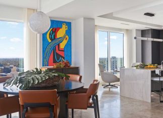 Modern Waterside Bliss in Tampa Condo Conducive to conversation, a round Minotti dining table framed with R. Hughes leather chairs from Caste Design offers an intimate gathering place for family meals. The Vistosi orb pendant light emulates the moon that glows over the shimmering water vistas at night. Artwork from the Henneckes’ collection creates a vibrant accent.