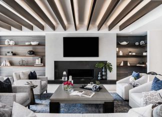 Allocated for leisurely activities like reading and watching television, the family room also plays host to book club meetings and serves as an overflow space for dinner guests. Wallcoverings crafted from natural horsehair hang behind floating shelves stocked with books and objets d’art. The designers had to significantly size down the fireplace mantel, which is fronted in Pompeii quartz.