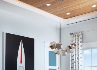 A dynamic artwork by Mat Sanders, Speed Boat 2, sourced from the Wendover Art Group, anchors the dining room. The dining table is made of mahogany finished in a warm neutral topped with a glaze. A dynamic red-and-white Pollock fabric on the host and hostess chairs creates a bright, resonant element in the space.