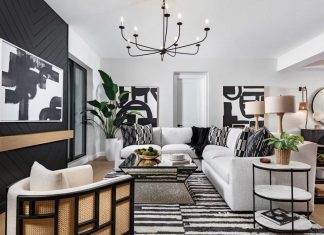 “It feels very grand for a smaller condo,” says interior designer Minka McDonald of the 2,500-square-foot residence. To fulfill the bold design direction in the living room, the design team chose a sectional sofa and throw pillows by Rowe Furniture, an ivory-and-charcoal striped area rug by Loloi, and a rattan-and-linen accent chair from Four Hands.