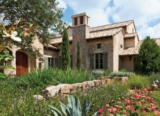 “This area of the front yard aptly represents the play in textures of green with the grasses contrasting with the broadleaf shrugs,” says landscape architect Patrick Trefz of Outside Productions. “We had a large specimen oak tree brought in to give the home a feeling that it had been built around something large.”