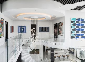 Massive Moxie in Modern Miromar Lakes Home Known as the gallery bridge, this second-floor space showcases multiple examples of the homeowners’ art collection, which features works from all around the world. The Graypants chandelier was selected for its ethereal qualities.