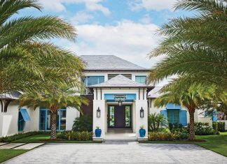 Blue Balinese-inspired shutters with matching planters define the cheerful façade of the two-story residence.