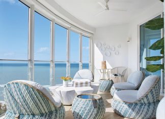 Naples Sky Residence is an Ocean-Inspired Oasis Ocean views never fail to entice family and guests onto the terrace for relaxing mornings and late afternoon entertaining. Dedon’s teal and seafoam woven wicker outdoor tables and lounge chairs provide ample seating around a Serena & Lily white tree-root coffee table.