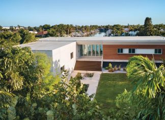 Inside Architect Jason Jensen’s St. Petersburg Home When open, the middle section of the home at the top of the stairs ensures breezes flow throughout the residence. The wood-clad wing with smaller windows on the right is where the house’s bedrooms are located.