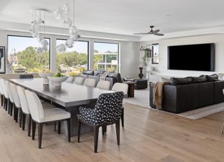 Sarasota Home Balances Warmth and Sophistication Vanguard chairs, upholstered in solid and patterned fabrics from Kravet, complement a custom dining table from Old Biscayne Designs. Blown-glass pendants housing air plants introduce a biophilic element that merges with the landscape. Trade Mark Interiors’ custom linear built-in delineates the living area along with the owners’ sectional and a custom Crescent rug.