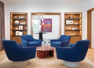 A chic conversation cluster in the sitting room centers around a red marble cocktail table by Antoni Pallejà for RS Barcelona, surrounded by cobalt blue swivel chairs with fuchsia welting by Jhon Ortiz for Tailored Hom