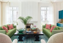 Alys Beach Home Boasts St. Tropez-Inspired Style In the main living room, interior designer Catherine Christie-Zanghi paired spring green-hued sofas with patterned persimmon pillows. The soft, rounded forms bring warmth against cream walls. A bold bar, reimagined in a pop of blue, stands apart in the open plan, while French cast panels clad the fireplace and echo the home’s sculptural, artful detailing.