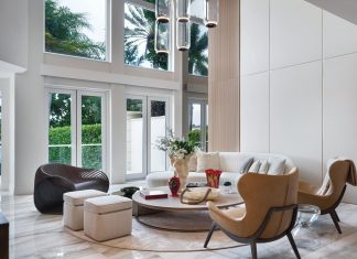 “The ceiling in the living room rises to about 21 feet, which allowed us to really play with scale, light, and proportion,” says Pernia. “That height brings a sense of openness and grandeur, while the warm materials and layered lighting keep the space feeling intimate and grounded.”