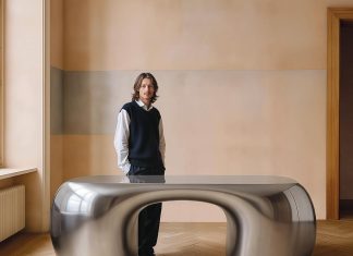 Designer Paddy Pike with the Arnardo desk, handcrafted in Spain