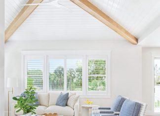 Anna Maria Island Home is a Ray of Sunny Coastal Transitional Style The design of the living room was about fashioning a space that’s both relaxed and refined. “The ceiling details and beams add architectural warmth,” says Moss, “while the blue accent chairs bring in a subtle coastal nod without feeling overly themed.” To soften the room, rounded forms were incorporated wherever possible.