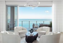 A seating area off the main living room reveals the residence’s spectacular views of the Gulf of Mexico. “We didn’t want to compete with the vistas, so one of our main challenges was to establish a refined color palette that wouldn’t veer toward being too white or too sterile,” says designer Carrie Riley. “Our inspiration came from the natural surroundings, mainly the sand and the ocean, which we reflected in our color and texture selections.”