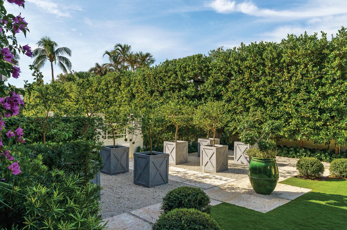 A series of potted trees and foliage creates a contemplative moment for guests as they stroll through the property&rsquo;s gardens. The design intent allows the landscape to guide visitors through the different garden sections.