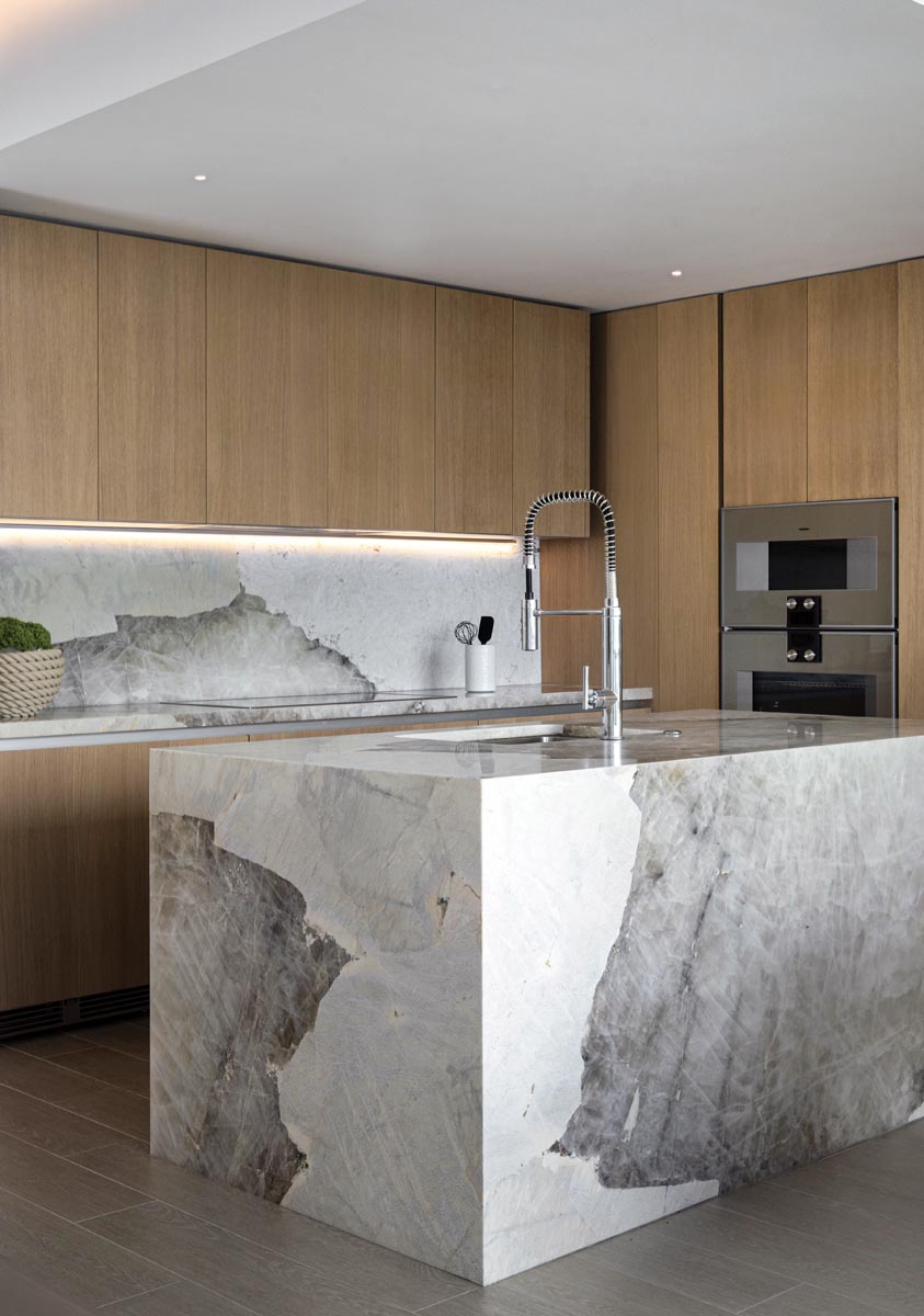 The kitchen&rsquo;s backsplash and island, fabricated by Victor Granite and Quartz, incorporate Patagonia marble slabs carefully book-matched so the veining flows continuously. Oak cabinetry by Italkraft grounds the space visually.