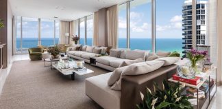 The main living room’s design is refined yet welcoming and centered around the view with a strong sense of balance and spatial organization. “Because of the room’s length, we divided it into two distinct zones: a TV/living area and a bar/lounge space for entertaining,” says designer Cristina Souza. “A custom extended sofa helps define these areas.”
