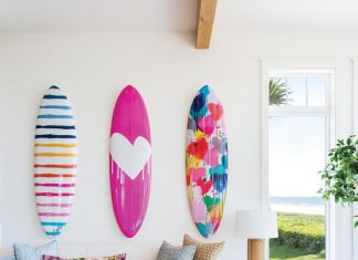 Cocoa Beach Vacation Home is a Surfer’s Paradise Because the main living area of the home is so large, designer Kate Abt created a couple of sitting nooks for quiet moments. On the wall, colorful surfboards by Kerri Rosenthal reveal the family’s love for the sport.