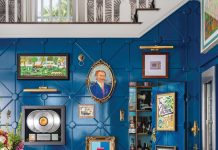 The bar is a showcase for artworks collected over the years. The mix of deep blue on the wall paneling and yellow on the stools is exemplary of the bold approach to palette exhibited throughout the residence.