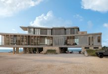 The residence is raised 10 feet off the ground to accommodate storm surge while improving exposure to the southeasterly trade winds. Louvered screens help protect and shade glass exposures while preserving the immersive views. The dwelling embraces natural daylight and cross-ventilation to further connect the occupants to the outdoors.