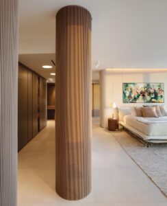 “We designed the primary suite as an open en-suite peaceful haven,” says Peribere. “An extra-large pivoting door opens to this space, which flows seamlessly between the bedroom, the dressing room, and the primary bathroom.”