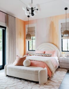 A layered palette of warm neutrals, blush tones, and creamy textures defines one of the children’s bedrooms. The Edge Collections wallcovering was chosen for its painterly quality and subtle movement.