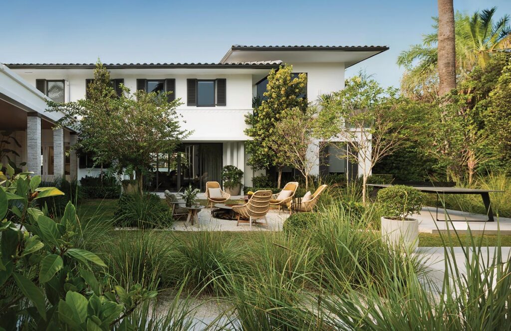 A verdantly landscaped courtyard offers one of the property’s most distinctive areas, anchored by a sculptural Moróro fire pit surrounded by woven club chairs. The adjacent ping-pong table is ideal for matches when the weather is right.