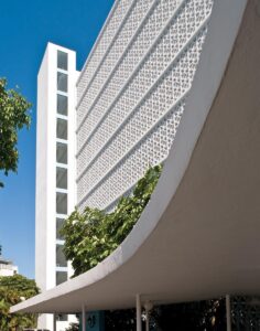 Designed by architect Herbert Mathes and completed in 1957, the waterfront Mediterranean Apartments building in Bay Harbor Islands uses a MiMo framework while nodding to the region’s earlier coastal aesthetics. Photo by Robin Hill