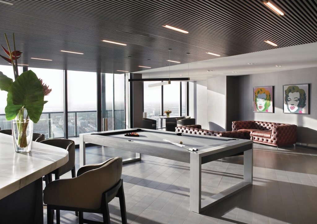 Designed for late-night conversation and leisure, the lower-level club room pairs expansive coastal views with a sophisticated social setting. Wolk anchored the entertainment space with luxurious tufted sofas by Addison House and a premier billiards table by Pool Table Portfolio.