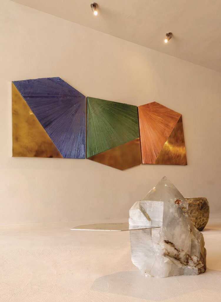 A corner in the new Alex Turco Gallery reveals the textured pieces the artist is known for. On the wall: Dusk to Dawn in Miami, a sculpture made with plaster, epoxy resin, acrylic paint, and brass. On the floor: the Ialino coffee table, made of cast brass and clear quartz, from the Only One collection.