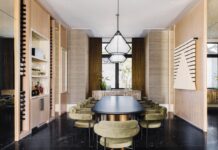 Pinecrest Family Home Balance Elegance and Comfort Nero Marquina marble flooring anchors the dining room and serves as a contrast to other textures, mainly the custom wallcovering and blond oak millwork. Nuevo Living chairs upholstered in green velvet surround a dining table by Made by Moniomi. Pendants by Gabriel Scott introduce a slight industrial vibe in the room.