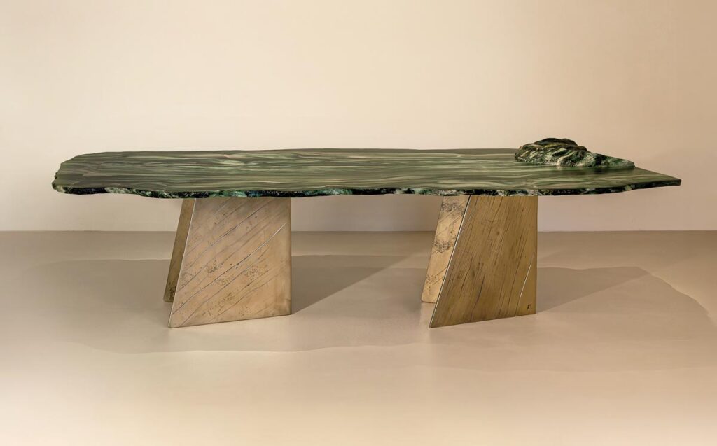 The Lapponio dining table from the Only One collection is handmade in cast brass, marble, and epoxy resin