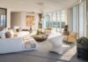 “The curved shape of the living area was challenging when it came to furnishing the space,” says designer Isabelle Peribere. “We opted for the curved Pianoalto sofa by Zanotta because it hugs the room and the Sherwood e Robin chandelier by Karman, a statement piece with personality that doesn’t block the views in any way.”
