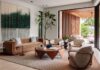 Golden Beach Home is a Study in Tropical Modernism The living room is the spatial heart of the main floor, anchored with a photographic artwork by Ana González that reinforces the home’s immersive connection to nature. A caramel-toned velvet sofa from RH, a sculptural wood-and-resin cocktail table from Espasso, leather lounge chairs from Poliform, and an organically inspired chair from Giorgetti are grounded by an area rug from Hechizoo.