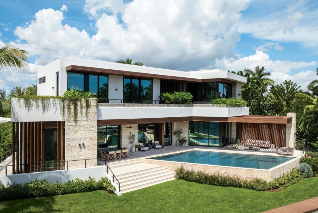 The outdoor living pavilion is one of the property’s most defining achievements. A pool by Strang Design runs the full width of the terrace at a lower level, with travertine coping and steps, and ends in a lawn that leads to a dock.