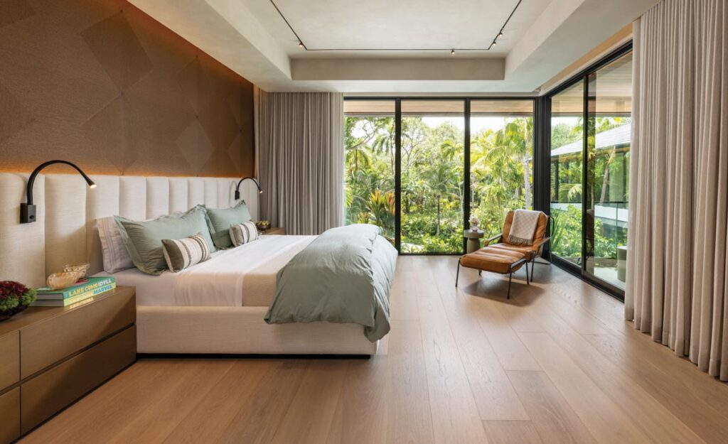The primary bedroom opens onto a secluded terrace overlooking the landscape. Flanked by Fulia’s bedside chests, a custom bed with an upholstered headboard by Design Solutions is poised to take in the view. Zanotta’s Maggiolina chaise provides a prime window seat.