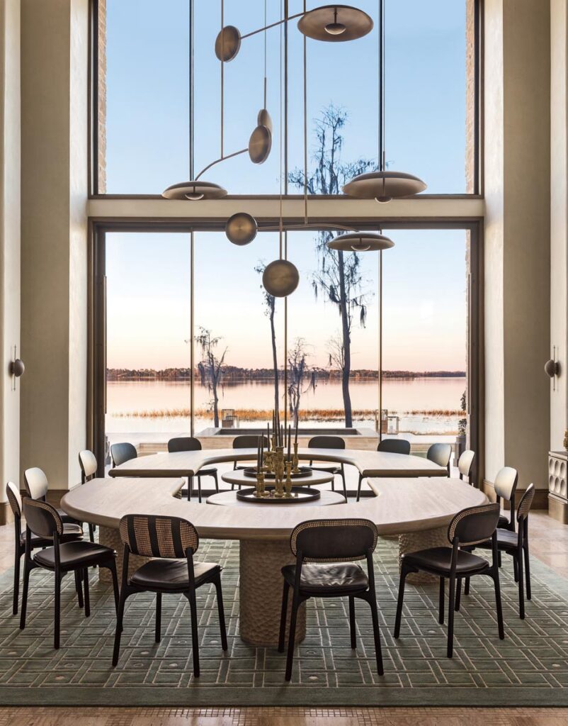 In the dining room, the custom designed table fabricated by Chris de Champlain consists of two U-shaped surfaces that can accommodate up to 18 diners. Above it are various Atelier001 pendants installed in a mobile formation.