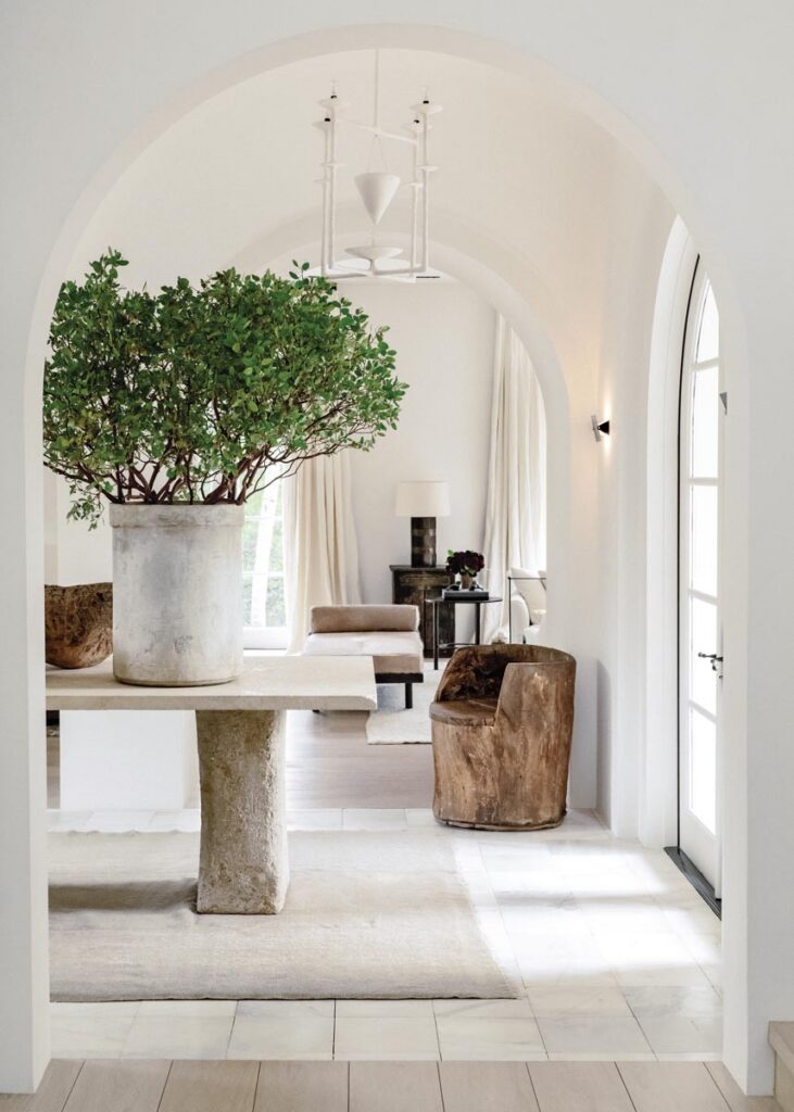 The arches in the residence’s foyer were reshaped by designer Briggs Edward Solomon, who “rounded the corners to make them more like a classic Roman arch.” The entry table is made of a solid piece of limestone from Formations, and on top of it sits a decorative planter by the renowned potter Willy Guhl. The marble flooring was sourced from Exquisite Surfaces.