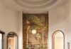 Inside a Central Florida Retreat Inspired by the Everglades The grand living room is anchored with Studio Piet Boon’s Derk sofas and carved marble coffee tables by Francesco Balzano. A custom mural by En-Viu pays homage to the Central Florida alligators and plant life surrounding the residence.