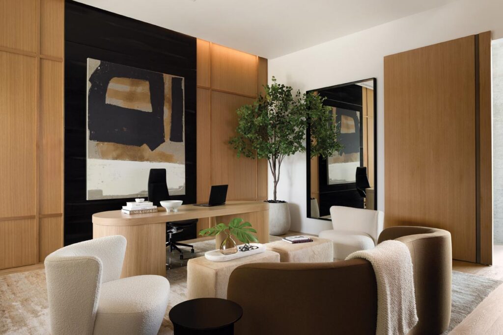 In the home office, a wave-like sofa by RH introduces fluid movement alongside a custom steel wall. A seamless oak door easily slides shut to create a private workspace.