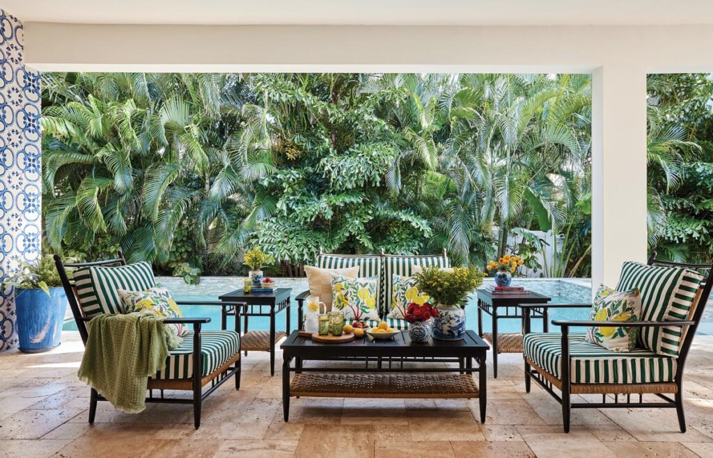 Through a set of double doors, the loggia is positioned close enough to feel like a true extension of the main living spaces. Outfitted with furnishings by Lloyd Flanders, the area serves as overflow for large gatherings and parties.